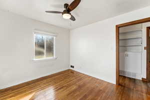 Spare room with dark wood-style floors and ceiling fan