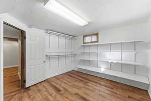 Walk in closet featuring light wood-style flooring