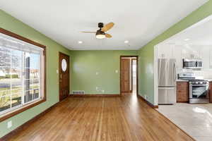 Foyer entrance with light wood-style flooring, a ceiling fan, and recessed lighting