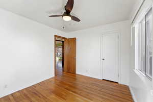 Unfurnished bedroom featuring light wood-style floors and a ceiling fan