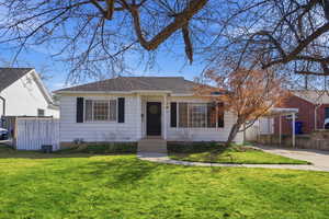 View of front of house featuring a carport and a shingled roof