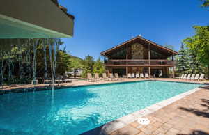 Community pool featuring a patio and a balcony