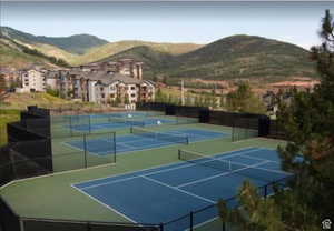 View of tennis court with a mountain view