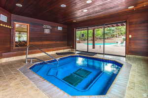 View of swimming pool featuring an in-ground hot tub