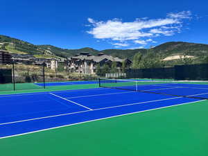 View of tennis court with a mountain view