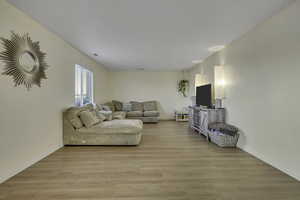 Living area with light wood finished floors and baseboards