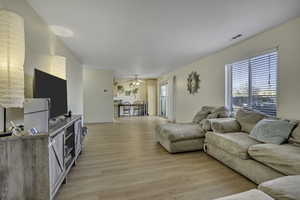 Living area featuring light wood finished floors and a ceiling fan