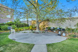 Fenced backyard with a patio area and grilling area