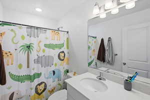 Full bath with vanity and curtained shower