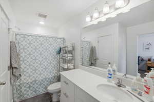 Bathroom featuring curtained shower and vanity