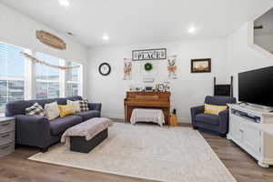 Living area with wood finished floors and recessed lighting