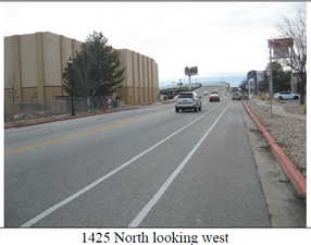 View of asphalt street with curbs and sidewalks
