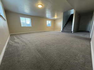 Below grade area with baseboards and carpet