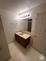 Bathroom with vanity, a stall shower, and light flooring