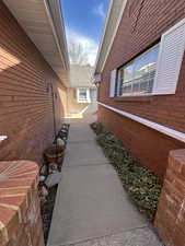 View of home's exterior featuring brick siding and roof with shingles