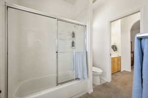 Full bath with light carpet, combined bath / shower with glass door, and vanity