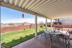 Fenced backyard featuring outdoor dining space and a patio