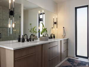 Full bathroom with double vanity and a shower stall
