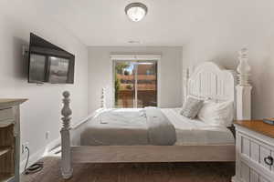 Bedroom featuring baseboards and access to outside