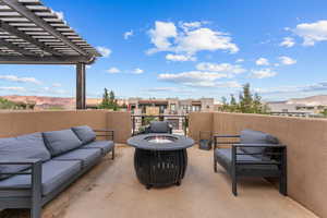 View of patio / terrace with an outdoor living space with a fire pit, a residential view, and a mountain view