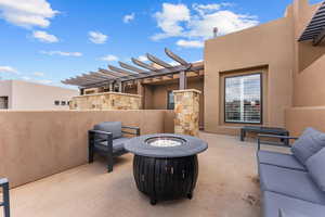 View of patio featuring an outdoor fire pit