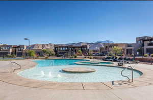 Community pool with a patio, a community hot tub, a mountain view, and a residential view