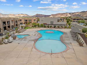 Community pool with a mountain view and a patio area