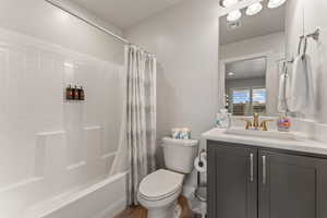 Bathroom with vanity and shower / bath combo with shower curtain