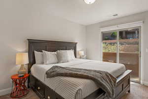 Bedroom with carpet flooring and access to outside