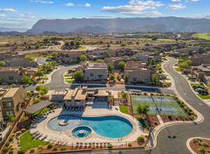 Aerial perspective of suburban area with mountains and a pool area