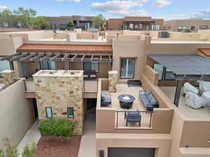 View of building exterior with a garage and a fire pit
