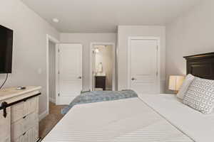 Bedroom featuring baseboards and connected bathroom