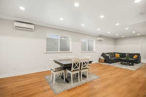 Dining space featuring light wood finished floors and recessed lighting