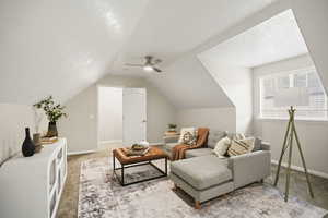 Upstairs bonus room featuring light carpet, ceiling fan, and vaulted ceiling