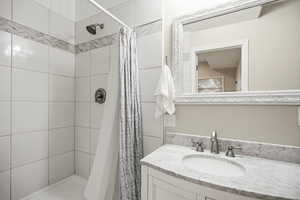 Full bathroom featuring a stall shower and vanity