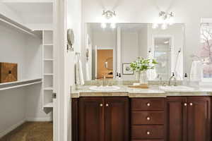 Mater bathroom with a walk in closet and double vanity