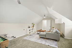 Upstairs bonus room featuring light carpet, ceiling fan, and vaulted ceiling