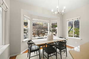 Dining area featuring hanging lights, light wood-style flooring, and healthy amount of natural light