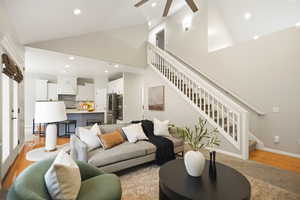 Family room featuring light wood-style flooring, recessed lighting, lofted ceiling, and ceiling fan