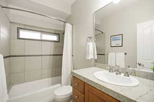 Main level full bathroom with vanity and shower / bath combination