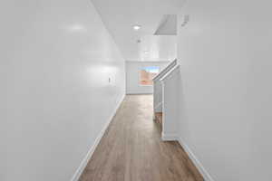 Hall featuring baseboards and light wood finished floors