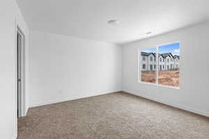Empty room featuring carpet floors and baseboards