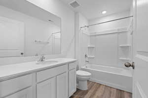 Full bath with light wood-style floors, vanity, and tub / shower combination