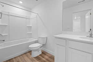 Full bathroom featuring vanity, light wood-style floors, and shower / tub combination