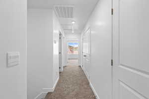 Corridor featuring light colored carpet and recessed lighting
