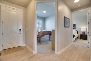 Corridor featuring light wood-type flooring