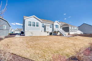 Rear view of property featuring stairway and a patio area