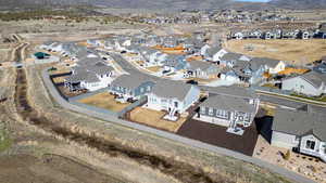 Aerial overview of property's location featuring mountains and nearby suburban area