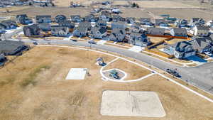 Aerial view of property and surrounding area with nearby suburban area
