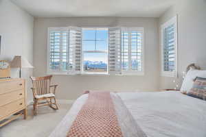 Bedroom with light colored carpet and baseboards
